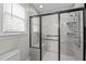 Walk-in shower featuring tiled walls, grab bars, a built-in bench, and a multi-setting showerhead at 104 Chuckwagon Dr, Louisburg, NC 27549