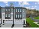 Eye-level view of modern townhomes with gray and white exteriors, each with a garage and driveway at 10516 Pleasant Branch Dr # 34, Raleigh, NC 27614