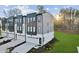 Modern townhome with gray siding, black accents, a driveway, and well-maintained landscaping at 10516 Pleasant Branch Dr # 34, Raleigh, NC 27614