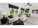 Bright living room and dining area with stylish furnishings, a ceiling fan, and large windows for natural light at 10516 Pleasant Branch Dr # 34, Raleigh, NC 27614