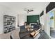 Open-concept living area with a decorative green wall, modern furnishings, and access to an outdoor space at 10516 Pleasant Branch Dr # 34, Raleigh, NC 27614