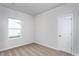 Neutral bedroom featuring plush carpeting, a window, and a white door at 11470 International Dr, Middlesex, NC 27557