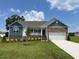 Charming single-story home featuring a manicured lawn, stone accents, and a two-car garage at 11470 International Dr, Middlesex, NC 27557