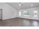 Bright living room features vaulted ceilings, wood-look floors, and ample natural light from the large windows at 11470 International Dr, Middlesex, NC 27557