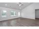 Bright living room features vaulted ceilings, wood-look floors, and ample natural light from the large windows at 11470 International Dr, Middlesex, NC 27557