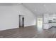 Open-concept living space with wood-look floors, vaulted ceiling, and seamless transition to the kitchen area at 11470 International Dr, Middlesex, NC 27557