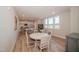 Open dining area with hardwood style floors, natural light, and adjacent kitchen at 1200 Gathering Park Cir # 302, Cary, NC 27519
