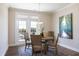 Cozy dining area with seating for four and natural light from the balcony doors at 1200 Gathering Park Cir # 302, Cary, NC 27519