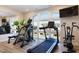Brightly lit home gym with arched windows and assorted exercise equipment at 1200 Gathering Park Cir # 302, Cary, NC 27519