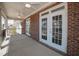 Covered patio featuring exposed brick and ceiling fans for outdoor enjoyment at 1200 Gathering Park Cir # 302, Cary, NC 27519
