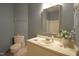 This bathroom features a vanity, toilet, and decorative wallpaper at 12124 Warwickshire Park, Raleigh, NC 27613