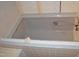 Built-in bathtub with a sliding glass door and tile surround at 12124 Warwickshire Park, Raleigh, NC 27613