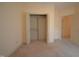 Bedroom with neutral carpeting and an open closet with double doors at 12124 Warwickshire Park, Raleigh, NC 27613