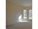 Neutral bedroom featuring carpet, with light coming in from large windows at 12124 Warwickshire Park, Raleigh, NC 27613