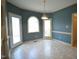 Cozy breakfast nook with wainscoting, a pendant light, and a door to the deck at 12124 Warwickshire Park, Raleigh, NC 27613