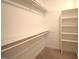 This walk-in closet offers lots of storage space with shelving and a clothing rack at 12124 Warwickshire Park, Raleigh, NC 27613