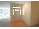 Bright entryway with hardwood floors and decorative sidelights around the front door at 12124 Warwickshire Park, Raleigh, NC 27613
