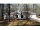 Charming single-story home nestled in a wooded lot with mature trees and a well-maintained lawn at 12124 Warwickshire Park, Raleigh, NC 27613