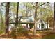 Single-story home featuring a bay window, mature trees, and spring flowers at 12124 Warwickshire Park, Raleigh, NC 27613