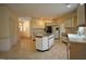 Open kitchen with an island, white appliances, and ample cabinet space at 12124 Warwickshire Park, Raleigh, NC 27613