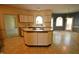 Bright kitchen featuring an island, white cabinets, and a large arched window over the sink at 12124 Warwickshire Park, Raleigh, NC 27613