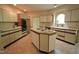 Spacious kitchen with a central island, white cabinetry, and built-in appliances at 12124 Warwickshire Park, Raleigh, NC 27613