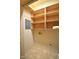 A laundry room with open wooden shelving at 12124 Warwickshire Park, Raleigh, NC 27613