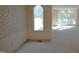 Spacious living room with decorative wallpaper, neutral carpet and an arched window at 12124 Warwickshire Park, Raleigh, NC 27613