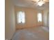 Spacious main bedroom with neutral tones and natural light from dual windows at 12124 Warwickshire Park, Raleigh, NC 27613