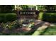 Community entrance sign surrounded by flowerbed and bushes at 12124 Warwickshire Park, Raleigh, NC 27613