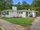 Tranquil backyard featuring a fire pit and seating area with a white home exterior and green lawn at 1243 Nc 231, Wendell, NC 27591