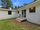 Backyard showing deck with slider, green grass and exterior of the house at 1243 Nc 231, Wendell, NC 27591