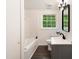 Well-lit bathroom featuring a sleek vanity, modern mirror, and combined shower and tub at 1243 Nc 231, Wendell, NC 27591