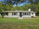 Charming exterior view of home featuring a manicured lawn, shuttered windows, and inviting front entrance at 1243 Nc 231, Wendell, NC 27591