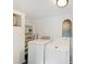Functional laundry room with white washer, dryer, shelving, and modern decor at 1243 Nc 231, Wendell, NC 27591