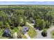 Aerial view capturing a blue house with manicured landscaping, nestled in a leafy residential area at 129 Camille Cir, Youngsville, NC 27596