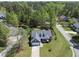 An aerial view of a well-maintained home with a lush lawn, mature trees and pristine landscaping at 129 Camille Cir, Youngsville, NC 27596