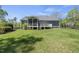 Charming home exterior with a well-manicured lawn, a screened-in porch, and a deck perfect for outdoor entertaining at 129 Camille Cir, Youngsville, NC 27596