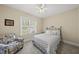 Bedroom featuring patterned chair, decorative pillows, iron bed frame and natural light at 129 Camille Cir, Youngsville, NC 27596