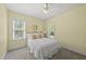 Bright bedroom with neutral decor, carpet flooring, and a ceiling fan at 129 Camille Cir, Youngsville, NC 27596