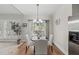 Cozy dining area with hardwood floors, a modern chandelier, and a sliding glass door to the outdoor space at 129 Camille Cir, Youngsville, NC 27596