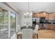Bright dining area with hardwood floors, slider access to the deck, and stainless steel kitchen appliances at 129 Camille Cir, Youngsville, NC 27596