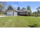 Charming home with stone accents, a pristine lawn, and manicured landscaping creating curb appeal at 129 Camille Cir, Youngsville, NC 27596