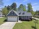 Charming single-Gathering home with a well-maintained lawn, stone accents, and attached two-car garage at 129 Camille Cir, Youngsville, NC 27596