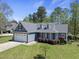 Beautiful blue home with a two-car garage, dormer windows, and well-maintained landscaping at 129 Camille Cir, Youngsville, NC 27596