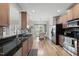 Eat-in kitchen features granite counters, stainless appliances, hardwood floors, and view of a dining area at 129 Camille Cir, Youngsville, NC 27596