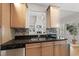 This kitchen offers wooden cabinets, stainless steel appliances, and a view into the living room at 129 Camille Cir, Youngsville, NC 27596