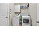 Well-organized laundry room with white appliances and storage shelves at 129 Camille Cir, Youngsville, NC 27596