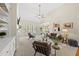 Bright, open living room with a vaulted ceiling, fan, and large windows bringing in natural light at 129 Camille Cir, Youngsville, NC 27596
