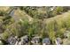 Aerial view of a home near a green golf course and lush trees showcases peaceful, outdoor living at 1335 Saint Andrews Dr, Mebane, NC 27302
